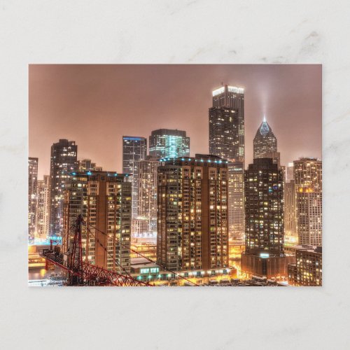 Snow falls over skyline at evening in Chicago Postcard