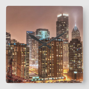 Snow falls over skyline at evening in Chicago Square Wall Clock