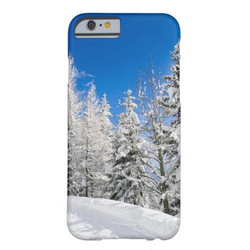 Snow trees under a clear blue sky phone case