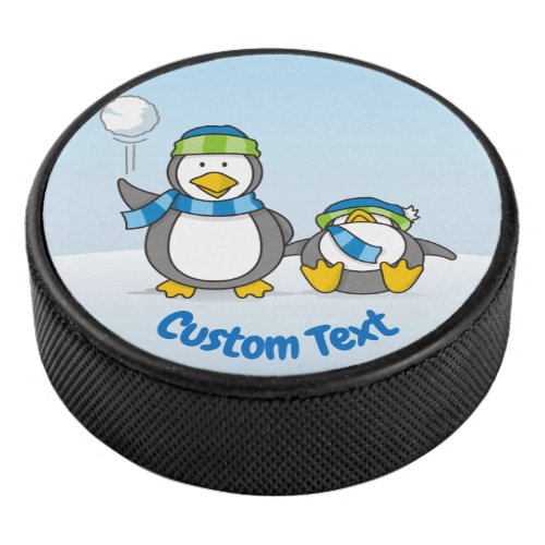 Snowballing penguins hockey puck