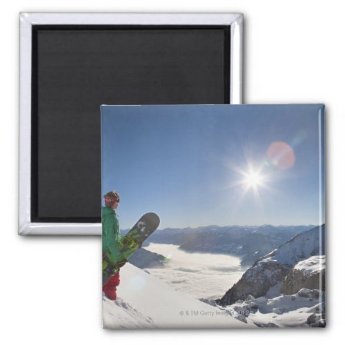 Snowboarder looking from mountain top magnet