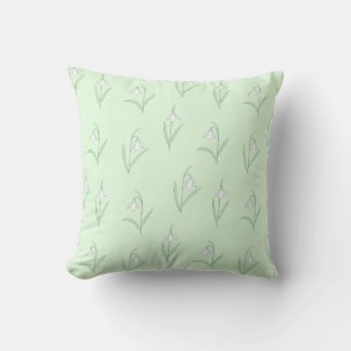 Snowdrops on green background throw pillow