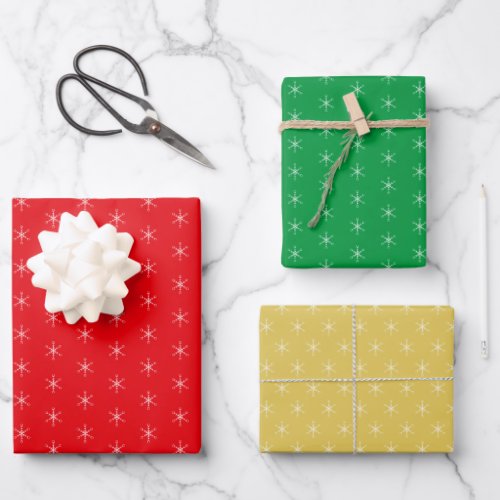 Snowflakes on Green Golden and Red Wrapping Paper Sheets