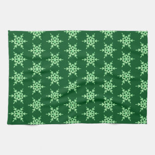 Snowflakes, pale green crystals on dark green towel