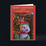 Snowman Christmas Grandson Card<br><div class="desc">Merry Christmas to Our Wonderful Grandson is written on the front of Christmas Greeting Card in green text on red background. Cheery Snowman hanging on tree branch of colorful lights with shiny red white ornament in background. Card can be personalized front and inside, or leave as is. Original Photography and...</div>