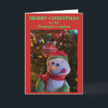 Snowman Christmas Grandson or Anyone Holiday Card<br><div class="desc">Merry Christmas to Our Wonderful Grandson is written in green typography against red background. Personalize for grandchild or anyone. Leave holiday greeting message inside vertical card, or personalize with your own. Cheery Snowman hanging on Christmas tree branch with colorful lights with shiny red white ornament in background. Leave festive Snowman...</div>