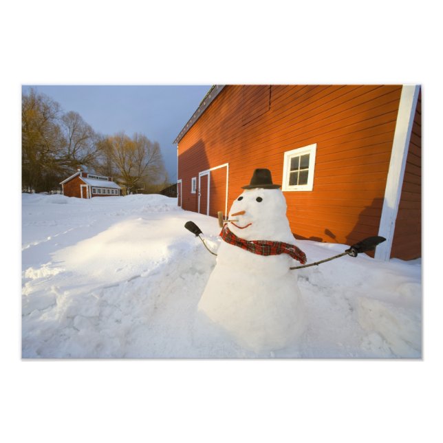 Snowman in front of red barn in Columbia Falls Photo Print (Front)