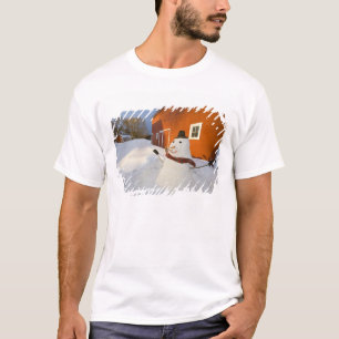 Snowman in front of red barn in Columbia Falls T-Shirt