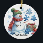 Snowman's Puzzle Wonderland Ceramic Ornament<br><div class="desc">Snowmen have their own unique talents; one such snowman is in wonderment while attempting to assemble puzzle pieces. This holiday tree ornament features a whimsical scene of a snowman with twig arms,  dressed to impress with puzzle pieces around him. A little holiday humor on this Puzzle Wonderland ornament.</div>