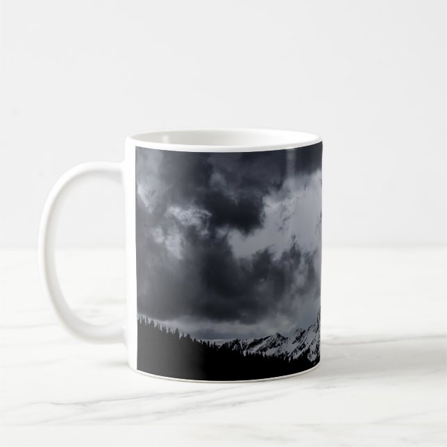 SNOWY MOUNTAIN UNDER DRAMATIC CLOUDS COFFEE MUG (Left)