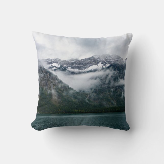 Snowy mountains in the fog at Plansee lake Throw Pillow (Front)