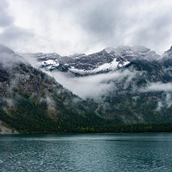 Snowy Mountains In The Fog At Plansee Lake   Watch by MarionsArtwork at Zazzle