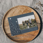 Snowy Pines | Elegant Christmas Photo Holiday Card<br><div class="desc">A modern and elegant Christmas holiday card design featuring a horizontal photo on a dark blue background adorned with pine trees laden with snow and topped with white stars. Personalize with your custom holiday greeting,  family name and the year.</div>