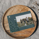 Snowy Pines | Elegant Christmas Photo Holiday Card<br><div class="desc">A modern and elegant Christmas holiday card design featuring a horizontal photo on a forest green background adorned with pine trees laden with snow and topped with white stars. Personalize with your custom holiday greeting,  family name and the year.</div>
