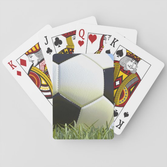 Soccer ball on grass. playing cards