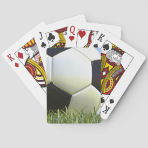Soccer ball on grass. poker cards