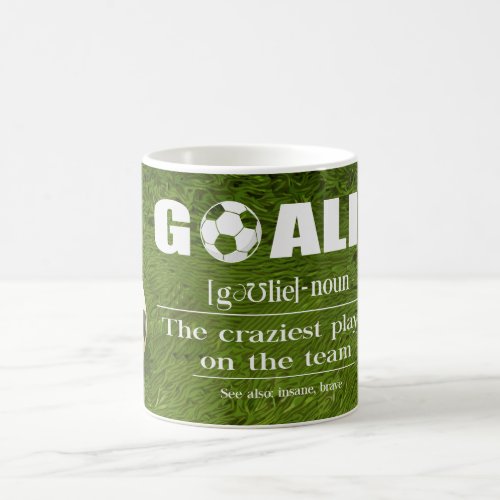 Soccer ball on green grass coffee mug