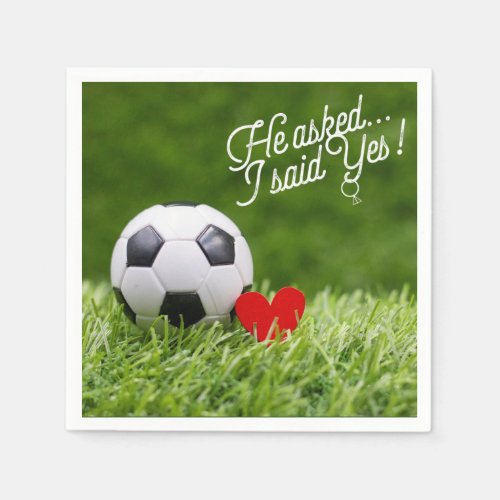 Soccer ball with red heart on green wedding napkin