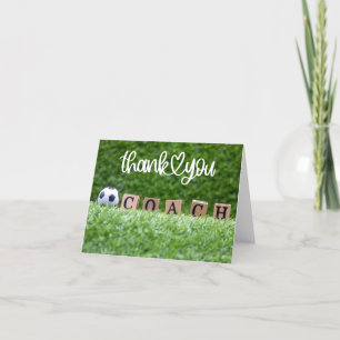 Soccer ball with thank you sign on green for coach card