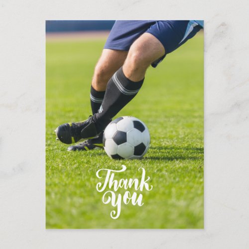 Soccer ball with word Thank you on green grass Postcard
