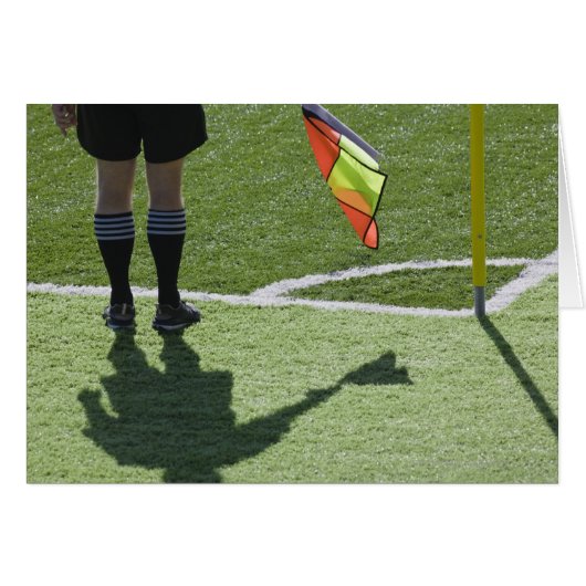 Soccer referee holding flag. (Front Horizontal)