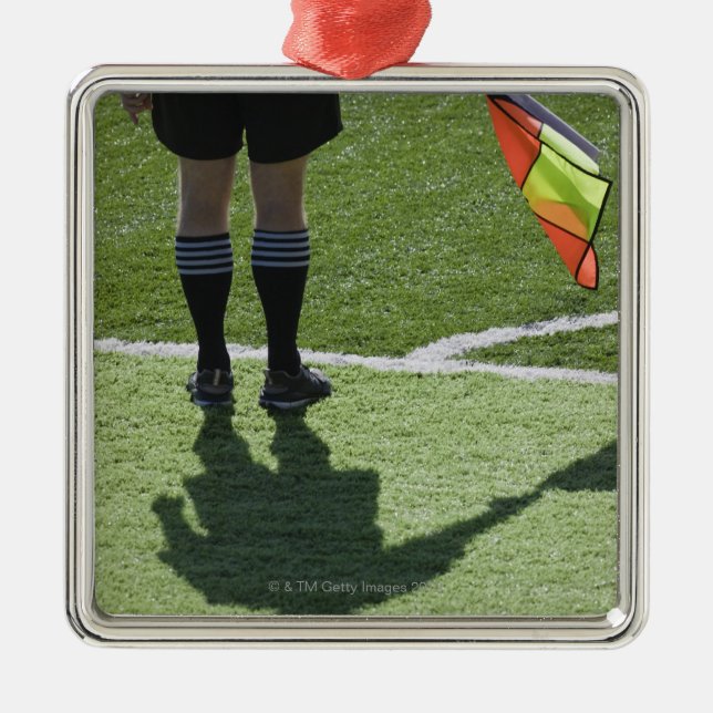 Soccer referee holding flag. metal ornament (Front)