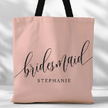 Soft Coral Pink Bridesmaid Modern Script Tote Bag<br><div class="desc">Show your appreciation to your bridal party with this stylish soft coral pink bridesmaid tote bag. Featuring modern script and customizable with your bridesmaid's name, this tote bag is both practical and elegant. The soft color and chic design make it perfect for carrying wedding day essentials or everyday items. This...</div>