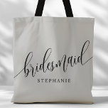 Soft Gray Bridesmaid Modern Script Tote Bag<br><div class="desc">Show your appreciation to your bridal party with this stylish soft gray bridesmaid tote bag. Featuring modern script and customizable with your bridesmaid's name, this tote bag is both practical and elegant. The soft color and chic design make it perfect for carrying wedding day essentials or everyday items. This personalized...</div>