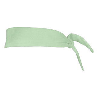 Soft mint-green background fills the image tie headband