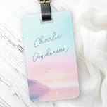Soft pastel sunrise with birds script name luggage tag<br><div class="desc">Luggage tag featuring your name in a handwritten style script over a soft,  pastel colored sunrise with a cliffs and two birds on the front. Add your contact information on the back.</div>