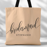 Soft Peach Bridesmaid Modern Script Tote Bag<br><div class="desc">Show your appreciation to your bridal party with this stylish soft peach bridesmaid tote bag. Featuring modern script and customizable with your bridesmaid's name, this tote bag is both practical and elegant. The soft color and chic design make it perfect for carrying wedding day essentials or everyday items. This personalized...</div>