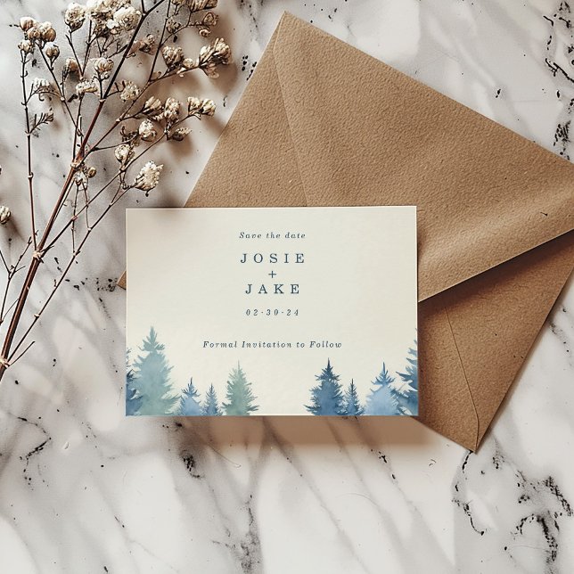 Soft pine trees save the date (Soft pine trees save the date card with bride and groom name and date next to a brown envelope.)