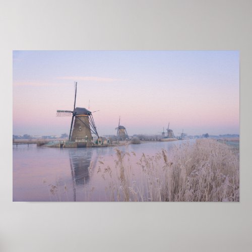 Soft sunrise light in winter over windmills poster