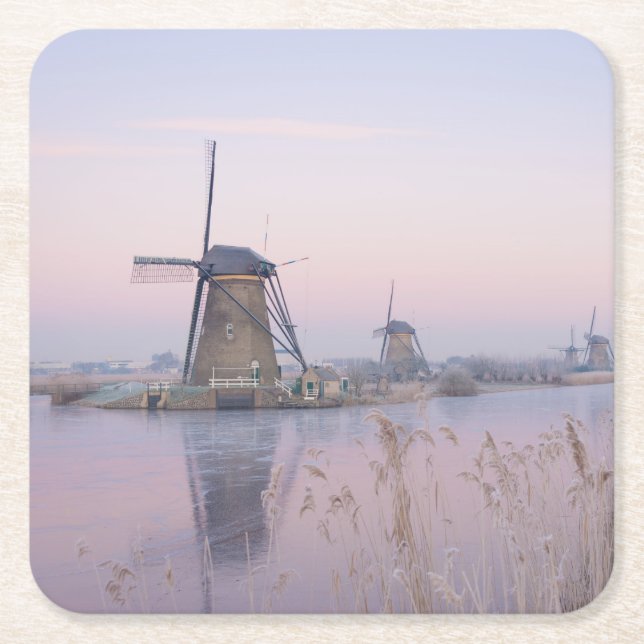 Soft sunrise light in winter over windmills square paper coaster (Front)