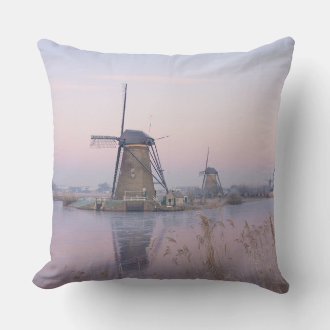 Soft sunrise light in winter over windmills throw pillow (Front)