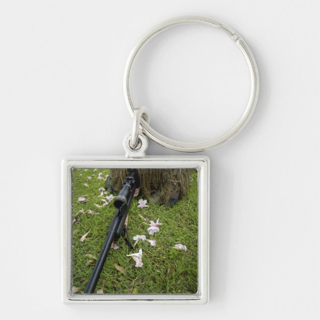 Soldier practices sniper tactics keychain (Front)