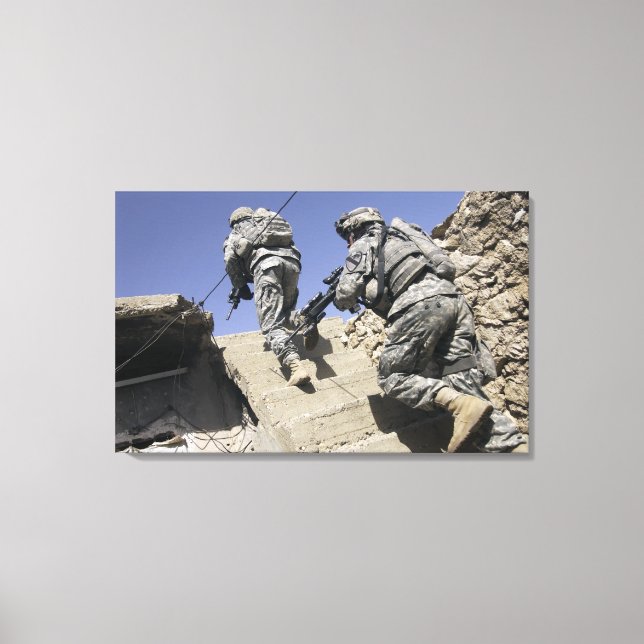Soldiers running up staircase of a building canvas print (Front)