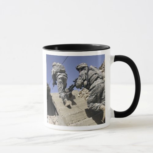 Soldiers running up staircase of a building mug