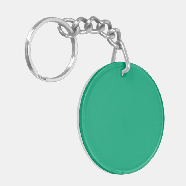 Solid teal background with a smooth texture keychain (Front Left)