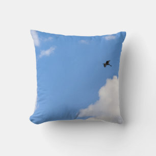 Solitary Bird Soaring Through Bright Blue Sky with Throw Pillow