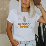 SONNY Groovy Bride Retro 70's Hippie Bachelorette  T-Shirt<br><div class="desc">This Groovy Bride bachelorette t shirt features boho daisies florals, a pace hand sign and a groovy retro themed font and color combination. This t shirt is perfect as a group gift for a bachelorette weekend. Grab the matching "Groovy babe" Shirt for a cohesive look. 💜 COLORS ARE EDITABLE! Click...</div>