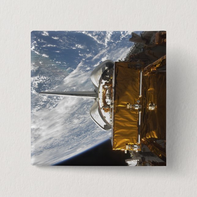 Space Shuttle Atlantis' payload bay backdropped Button (Front)
