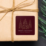 Sparkling Winter Pine Burgundy Merry Christmas Square Sticker<br><div class="desc">Elegant Christmas stickers featuring snowy faux gold foil pine trees with a burgundy background (or color of your choice). "Merry Christmas" is displayed in a white, modern serif font with your name or custom text below. The personalized holiday stickers are perfect to use for sealing Christmas card envelopes, gift wrapping,...</div>