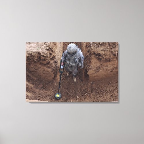 Specialist searches for a weapons cache canvas print