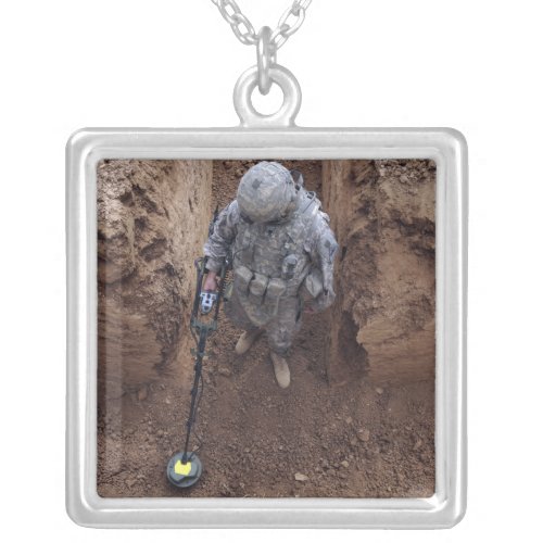 Specialist searches for a weapons cache silver plated necklace