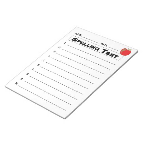 Spelling test notepad with a red apple