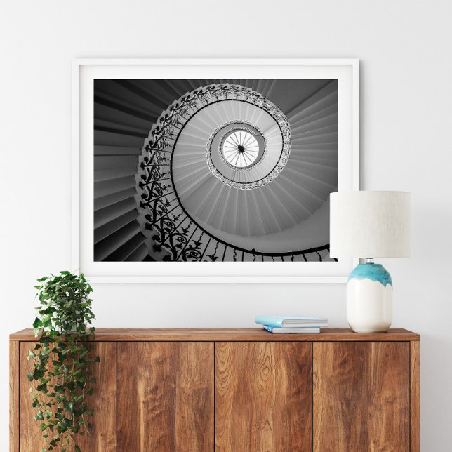 Spiral Staircase with Flowers Poster (Spiral Staircase with Flowers Poster in a white frame above a small furniture.)