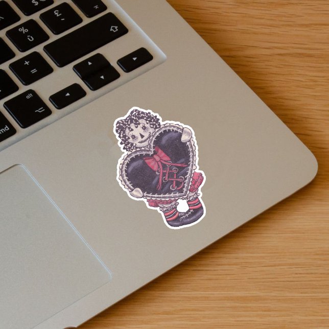 Spooky Rag Doll Yarn Hair Big Black Heart Red Bow Sticker (Spooky rag doll pale face black yarn look hair with black heart red bow on vinyl sticker.)