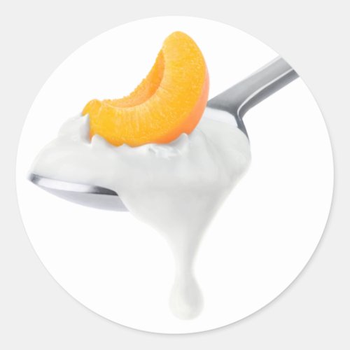Spoon of peach or apricot yogurt classic round sticker
