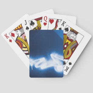 Sprayed graffiti on blue metal poker cards